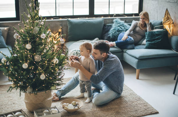 Father and daughter decorate a christmas tree | Flooring By Design