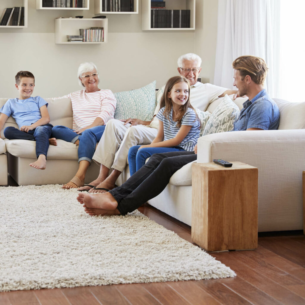 Happy family on living room | Flooring By Design