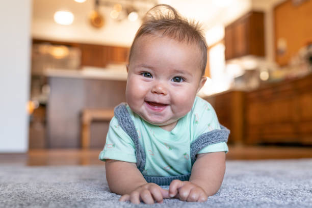 Baby lying on carpet flooring | Flooring By Design